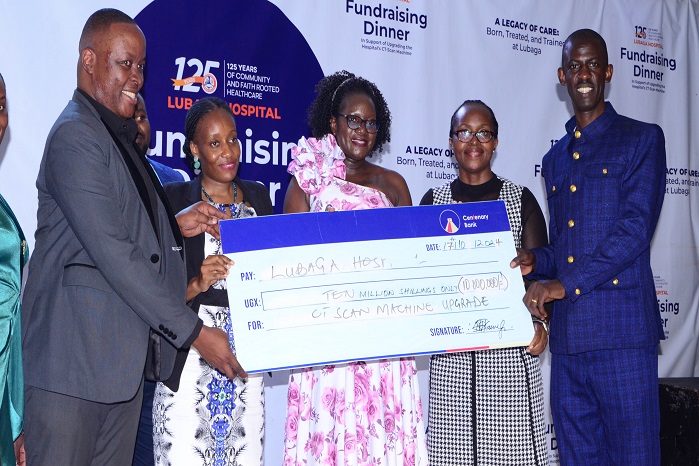 Dr. Julius Luyimbazi, Executive Director, Lubaga Hospital (Right) receiving a dummy cheque from Centenary Bank Team