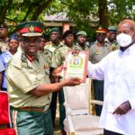 Brig Gen Francis Chakwiya from Zimbabwe National Defence University presents a gift to President Museveni after an opportunity lecture at State
