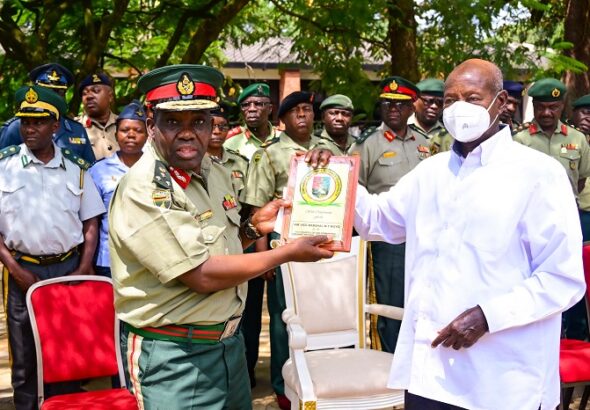 Brig Gen Francis Chakwiya from Zimbabwe National Defence University presents a gift to President Museveni after an opportunity lecture at State