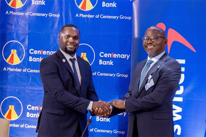 Interswitch Uganda Country General Manager, Moris Seguya (L) and Centenary Bank Managing Director Fabian Kasi (R) while announcing the partnersh