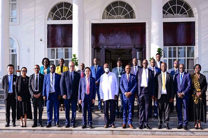 President Museveni poses for a photo with Food and Agriculture Organisation (FAO) Director General Qu Dongyu (on his R) and his delegation (L) a