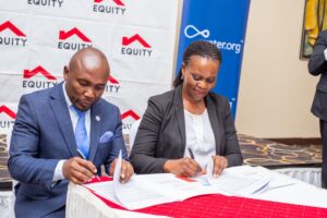 Equity Bank Director of Public Sector and Social Investment, Catherine Psomgen signing the MoU, with Water.org Africa Regional Director Francis Musinguzi at Protea Hotel yesterday. The partnership wi(3)