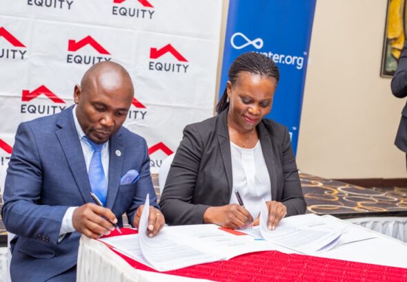 Equity Bank Director of Public Sector and Social Investment, Catherine Psomgen signing the MoU, with Water.org Africa Regional Director Francis Musinguzi at Protea Hotel yesterday. The partnership wi(3)