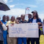 Fred Bwino Kyakulaga the State Minister of Agriculture, Animal Industry and Fisheries presents a dummy cheque of UGX 1.2b with Equity Bank’s Director of Public Sector And Social Investment Catherine P