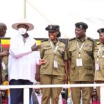 President Museveni shares a light moment with some of the officers who were awarded medal during the NRM Liberation day celebrations at Kololo on Monday. PPU Photo