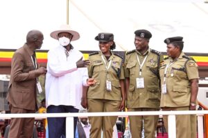 President Museveni shares a light moment with some of the officers who were awarded medal during the NRM Liberation day celebrations at Kololo on Monday. PPU Photo