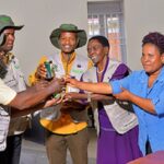 ECOTRUST Local government officials handing over vegetable seedlings to model farmers.